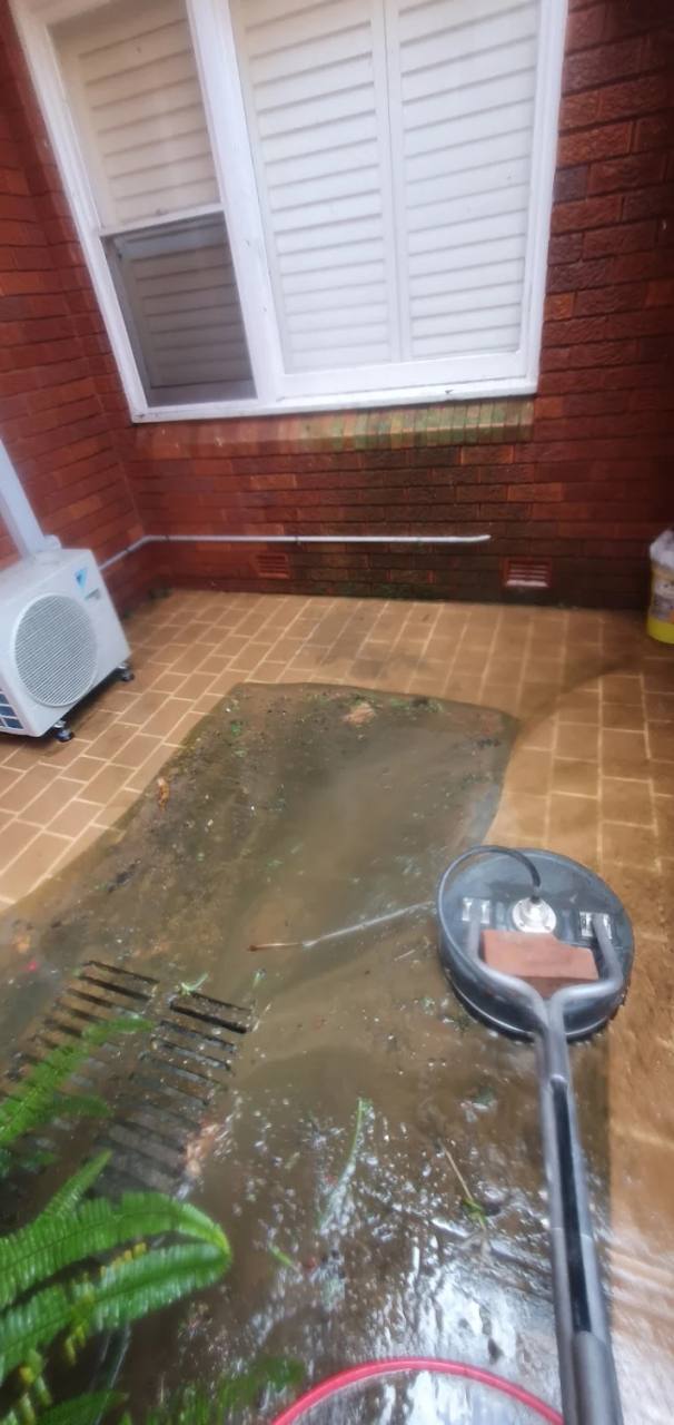 Aquastar surface cleaner working across a tiled courtyard