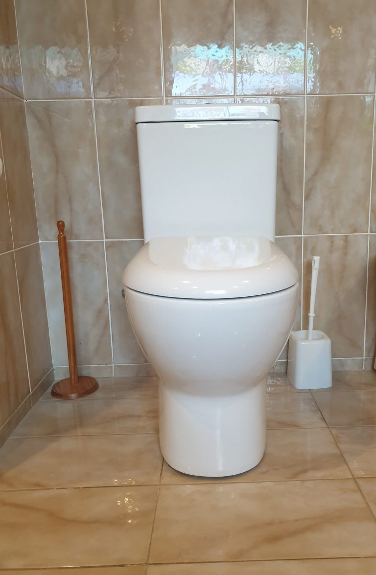 New white close-coupled toilet after installation