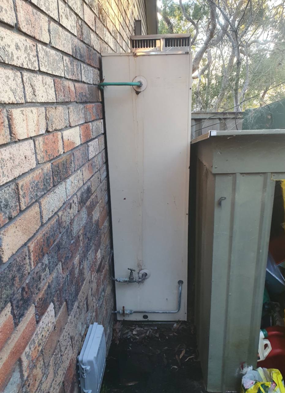 Old outdoor storage hot-water system before replacement